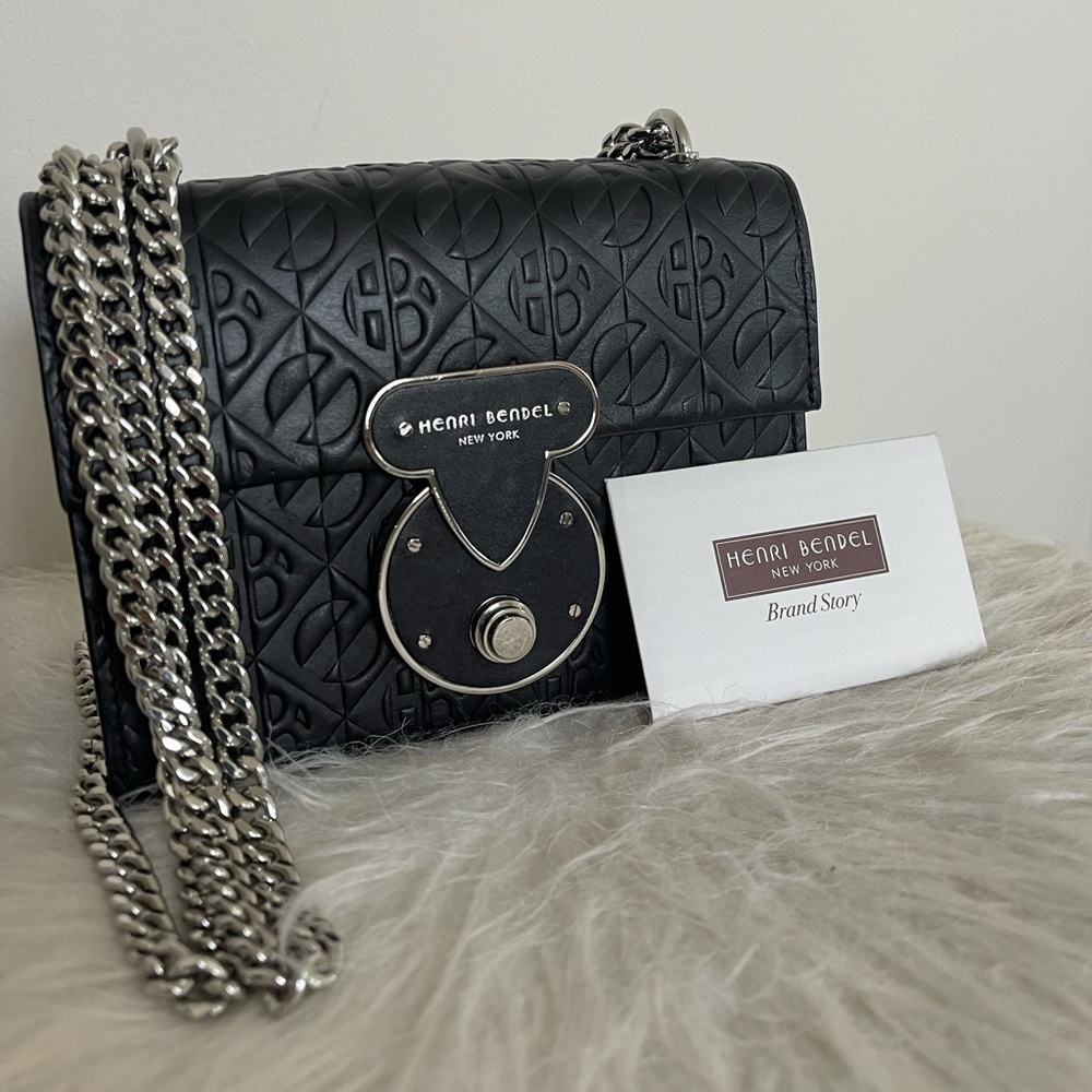 Black leather Henri Bendel mini bag. Silver chain.